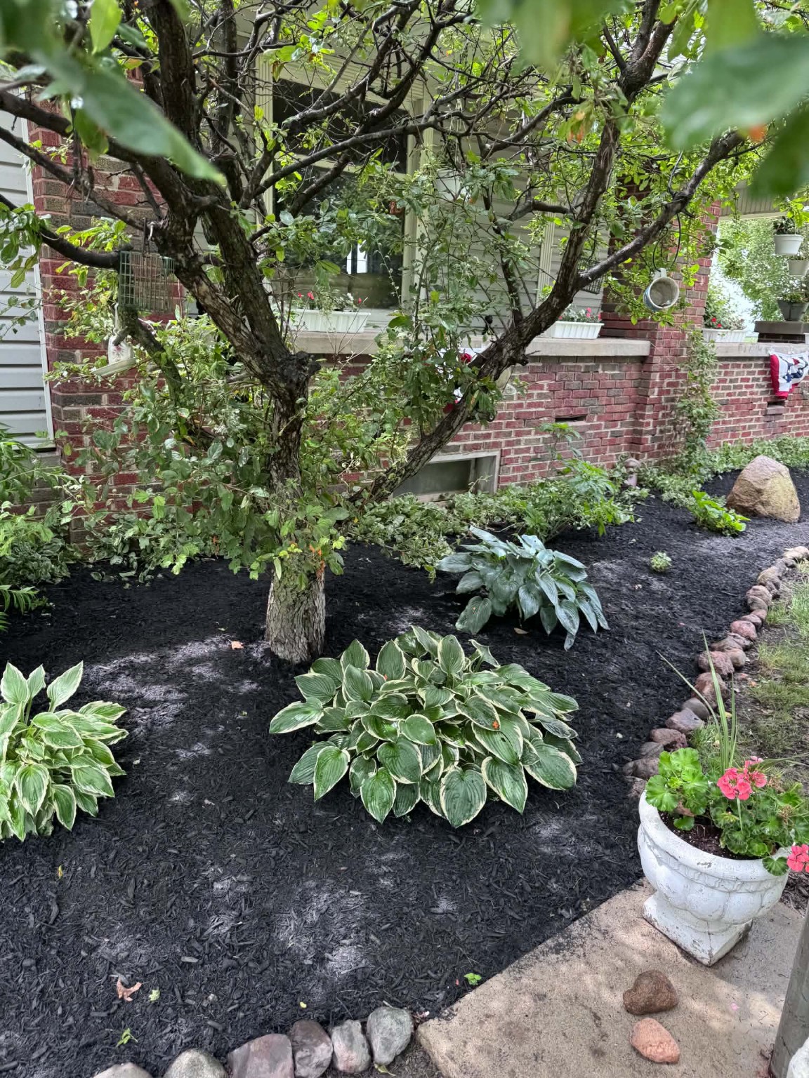 Mulch Installation: Garden beds and decorative stone borders