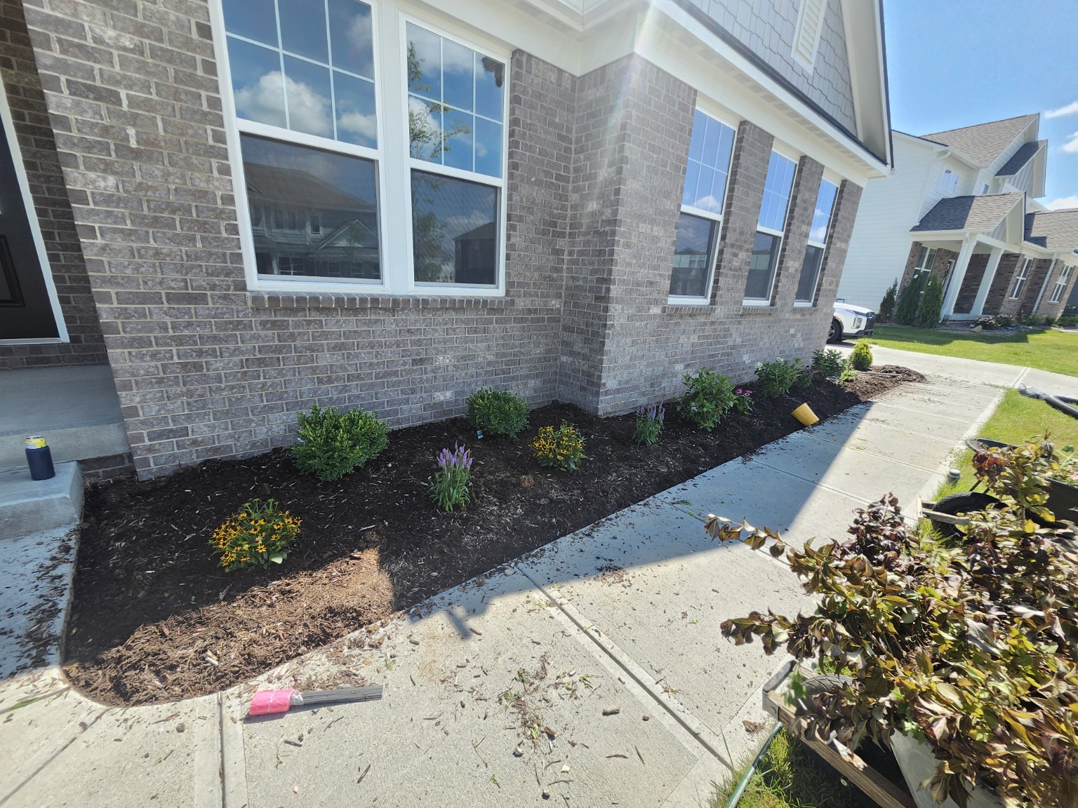Fresh black mulch and flowers along front walkway
